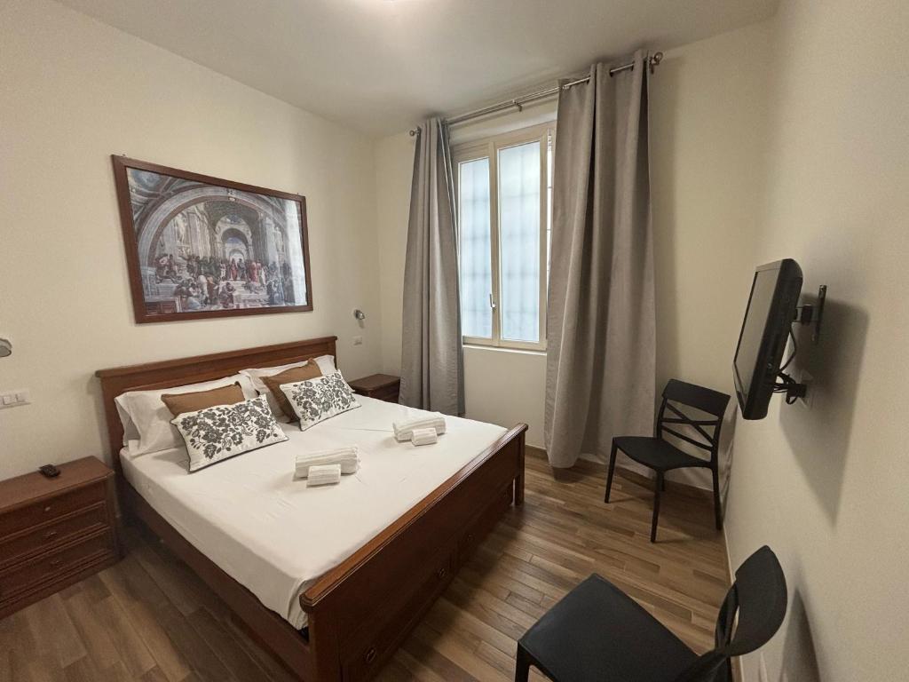a bedroom with a bed and a tv in it at Residenza Vignoli Seregno Centro in Seregno
