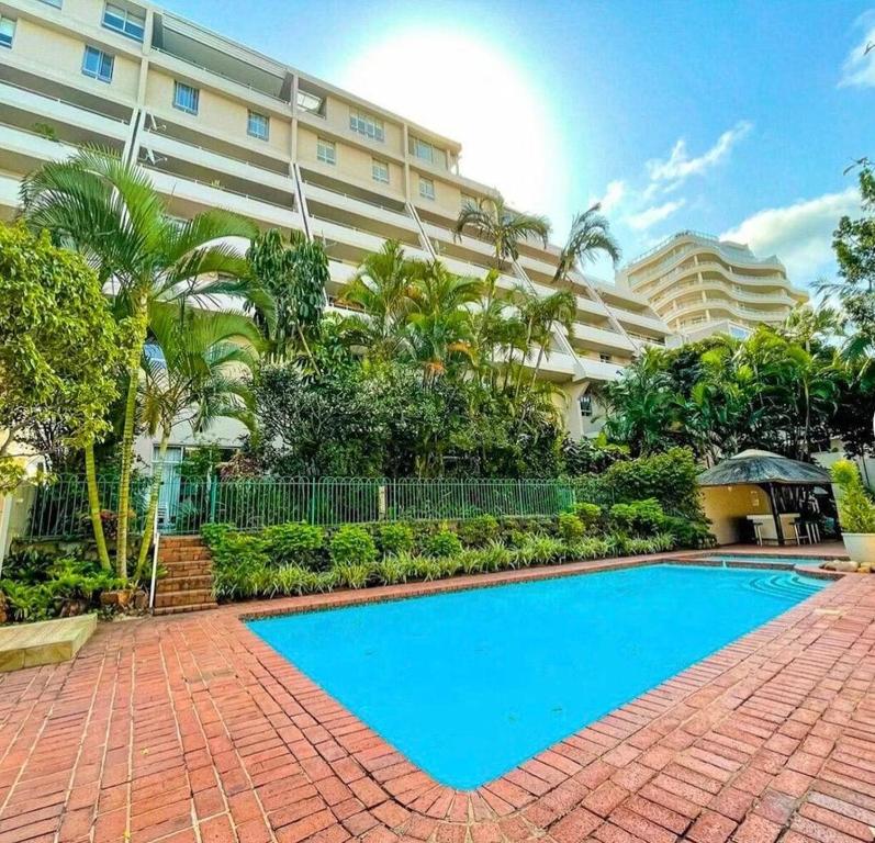 a swimming pool in front of a building at 18 Ipanema Beach in Durban