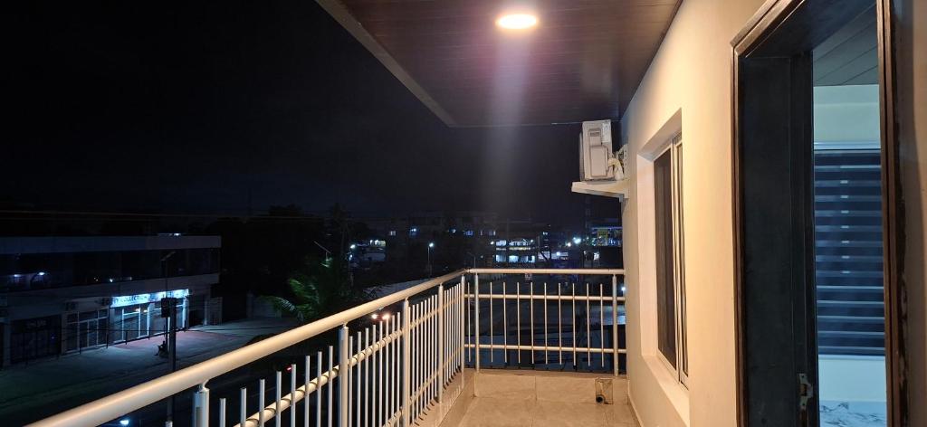 a balcony with a view of the city at night at TEE Guest House in Monrovia