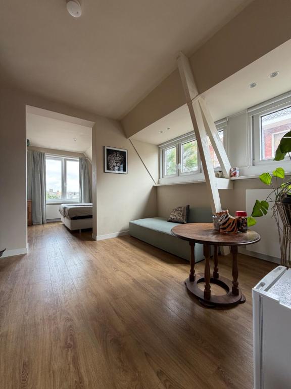 a living room with a couch and a table at Weltevreden in Noordwijk