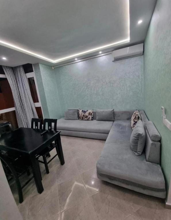 a living room with a couch and a table at Comforts apartment 3 in Fnidek