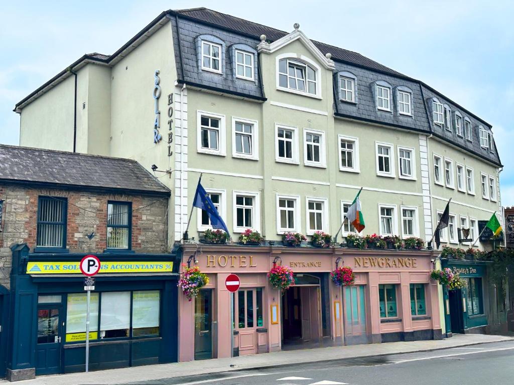 a large white building on a city street at The Newgrange Hotel in Navan