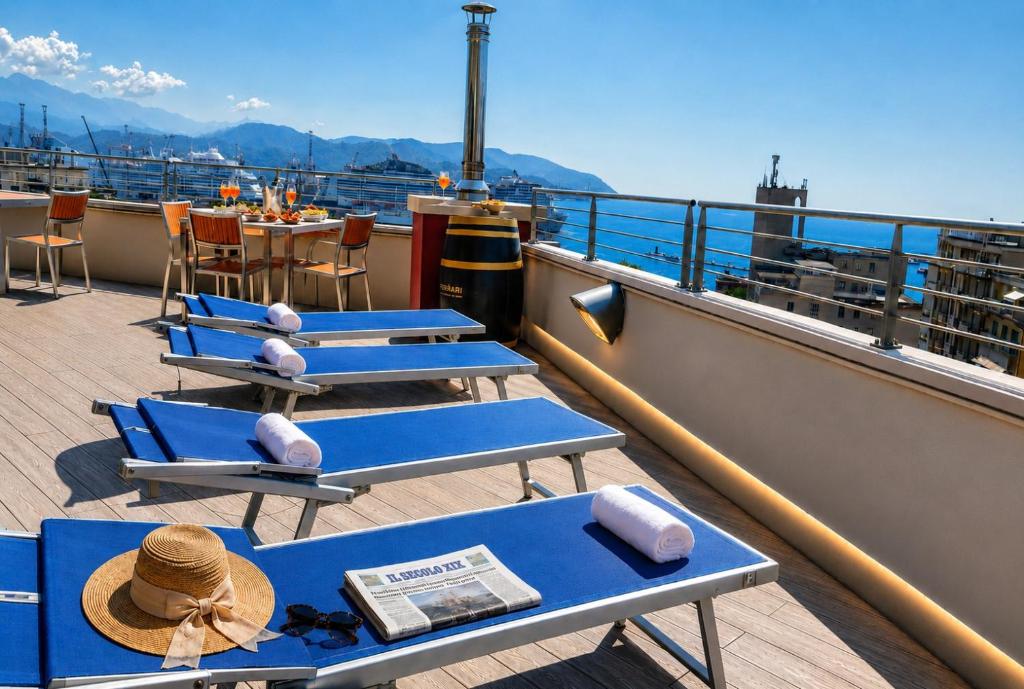 a balcony with blue tables and chairs on a ship at Allegroitalia La Spezia 5 Terre in La Spezia