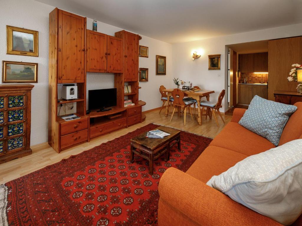 a living room with a couch and a table at Studio Terrasse Des Alpes 618 by Interhome in Crans-Montana