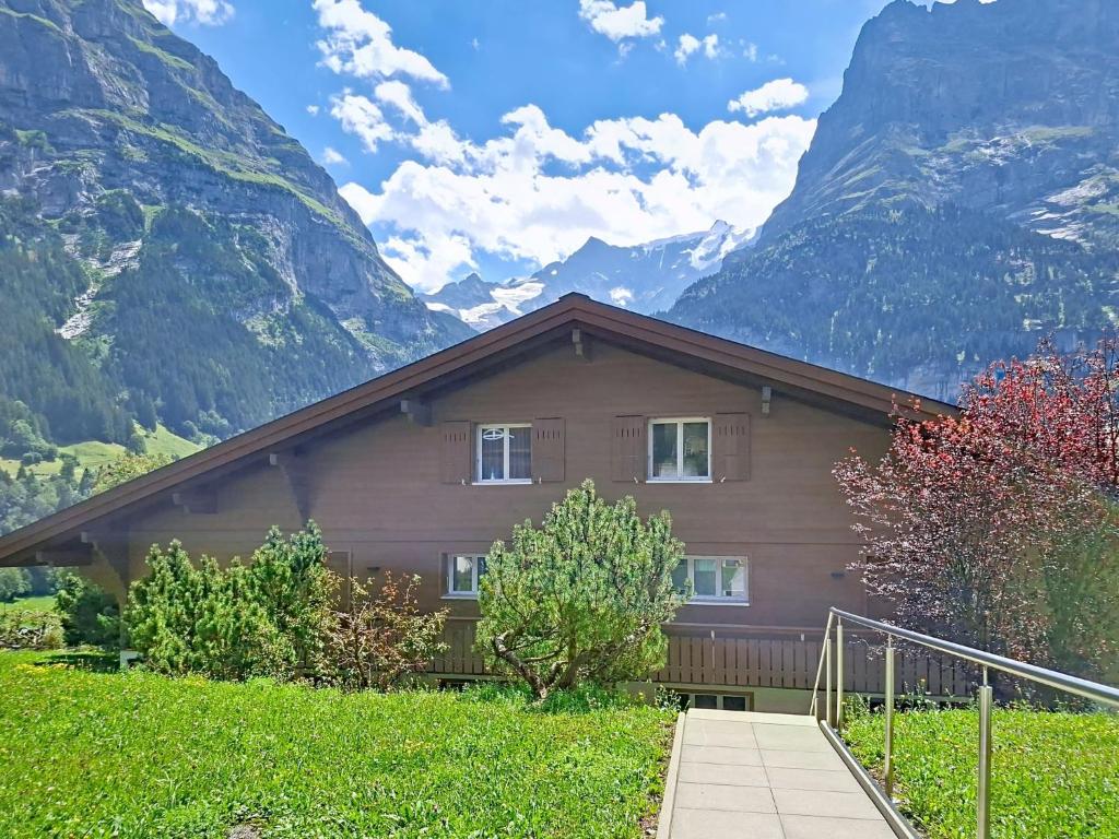 a house in front of a mountain at Apartment Chalet Almis 5 by Interhome in Grindelwald