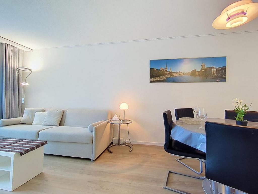 a living room with a couch and a table at Apartment Allod Park Haus B 202 by Interhome in Davos
