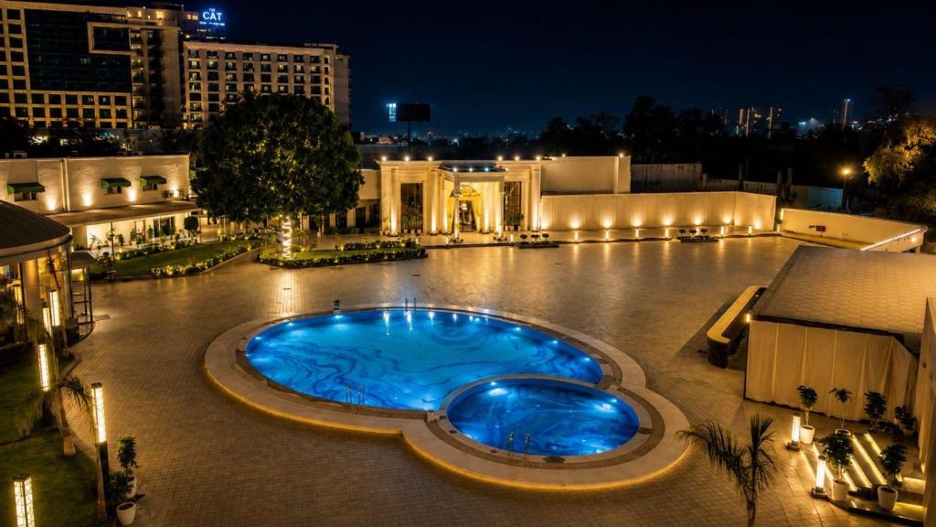 a large pool in the middle of a building at night at White Wharf Manesar in Gurgaon