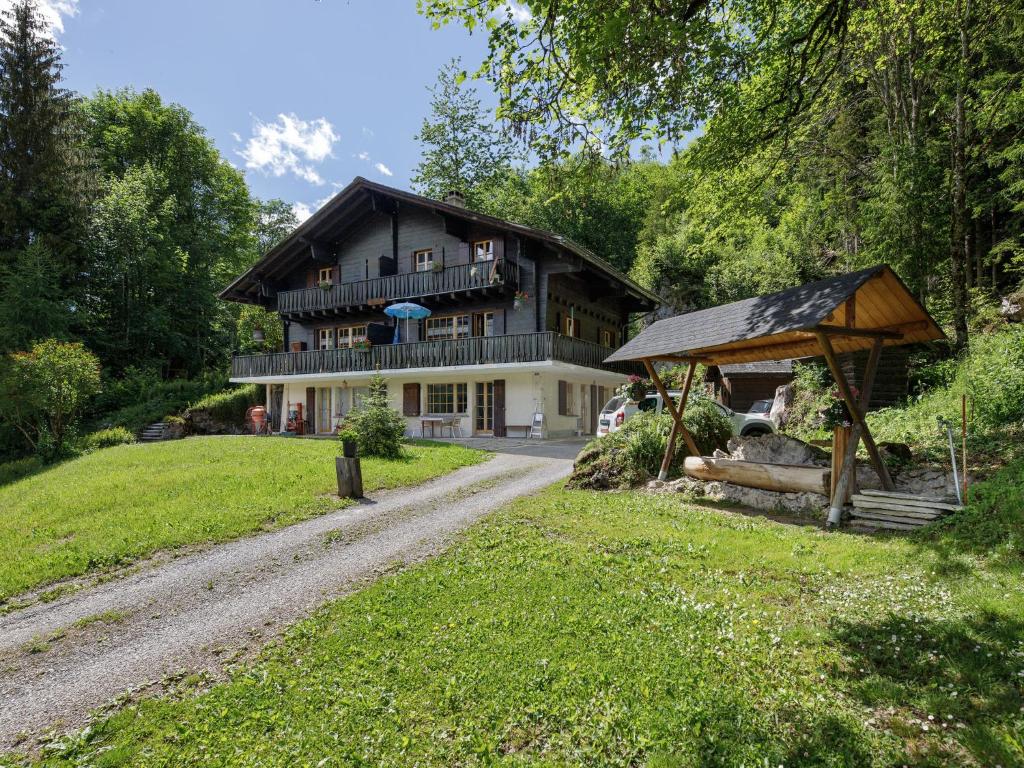 a house with a gravel road in front of it at Apartment Chalet L'Aube by Interhome in Vers L'Eglise