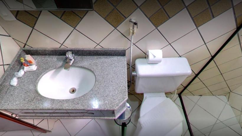 a bathroom with a sink and a toilet at Pousada dos Girassóis in Palmas