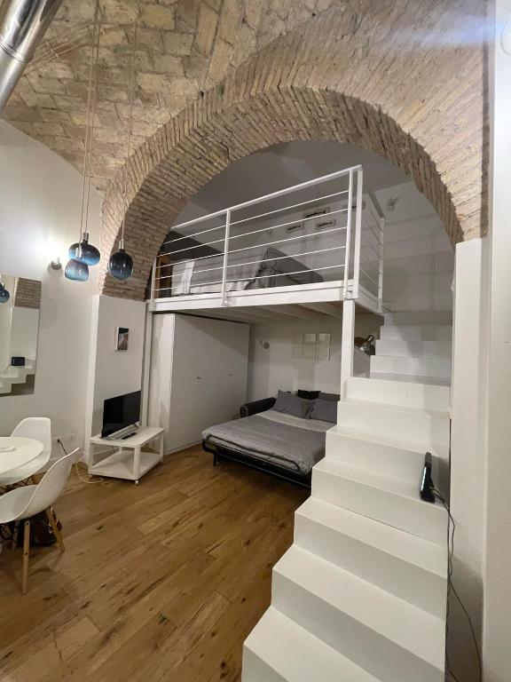 a bedroom with a bed and stairs in a room at 16 zeros villa in Paralia Katerinis