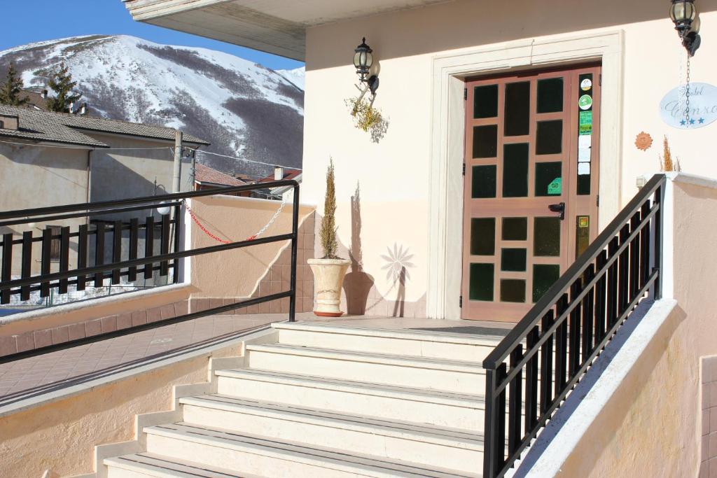 a house with stairs leading to a door at Hotel Cenzo in Ovindoli