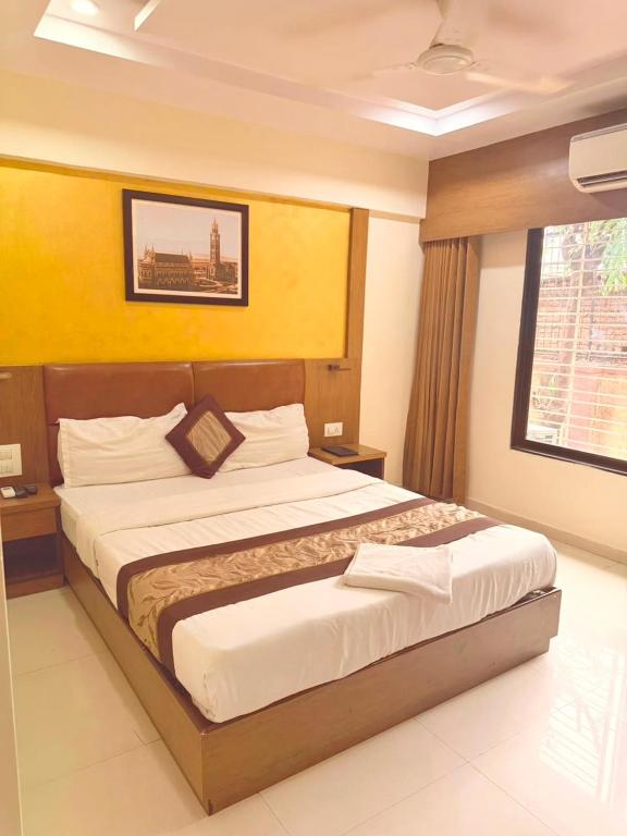 a bedroom with a large bed in a room at Crystal Luxury Hotel in Mumbai