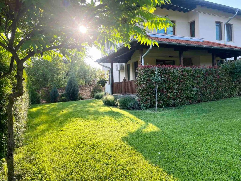 a house with a lawn in front of a house at Вила Магнолия in Lakarevo