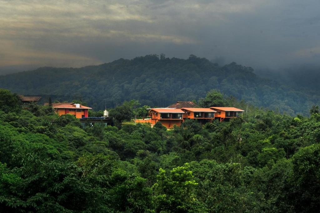 a group of houses on top of a mountain at Indo Asia Heritage Coorg, formerly Heritage Resort Coorg in Madikeri