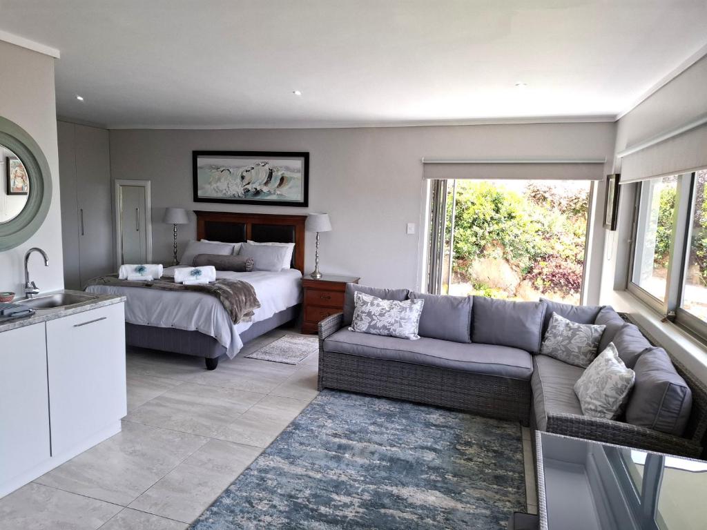 a living room with a bed and a couch at 80 on Rodger in Linkside