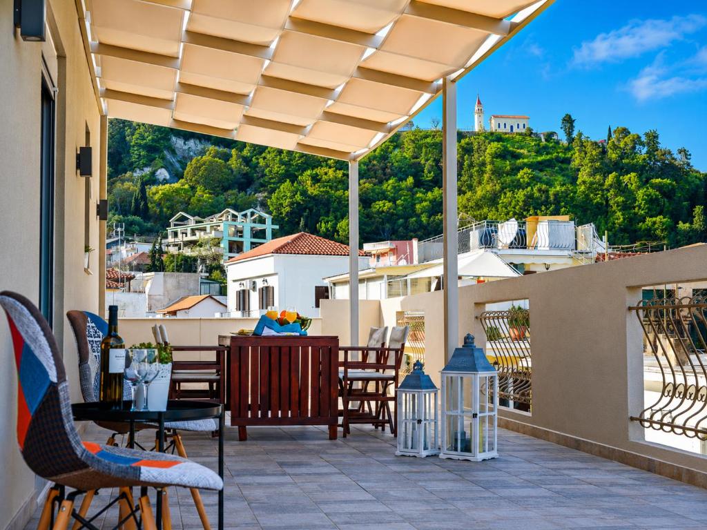 a patio with chairs and a table with a view at Victor Junior Suite by "elite" in Zakynthos