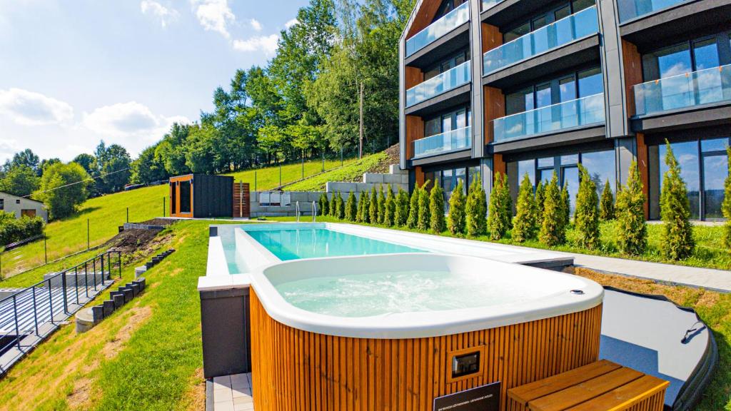 a hot tub on the side of a building at Wisła View, Sun&Snow in Wisła