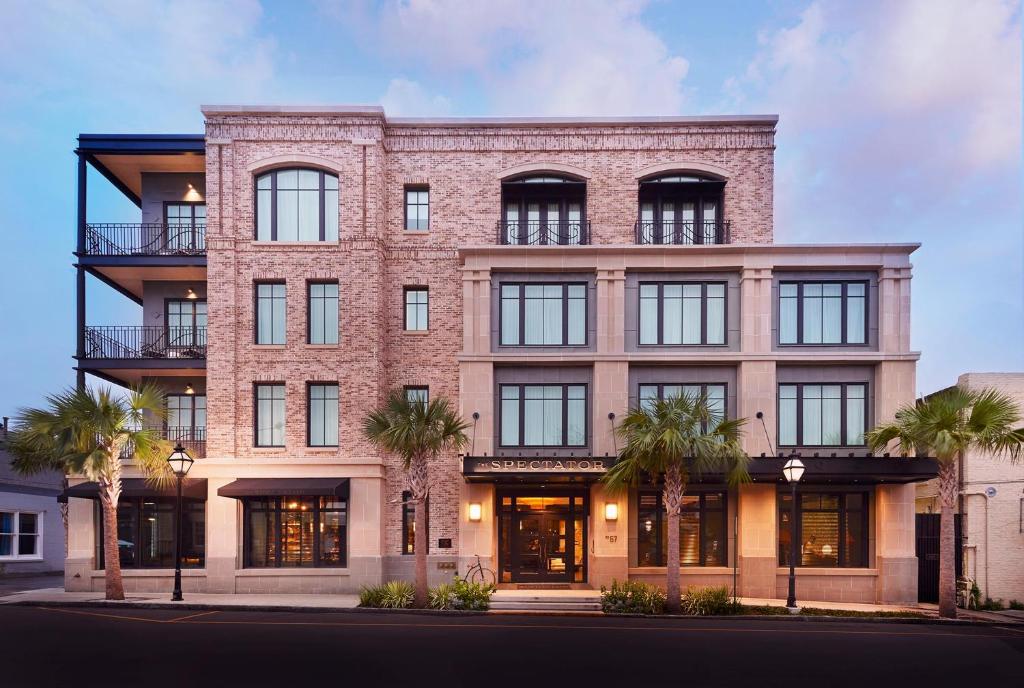 a large brick building with a large window at The Spectator Hotel in Charleston
