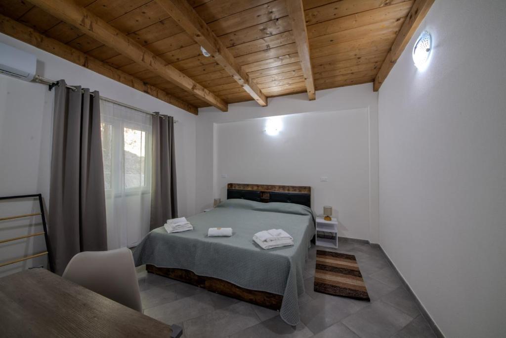 a bedroom with a bed and a chair in it at Casale in legno nella natura laziale in La Giustiniana