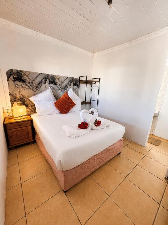 a bedroom with a bed with two towels on it at Nairobi Guesthouse in Orkney