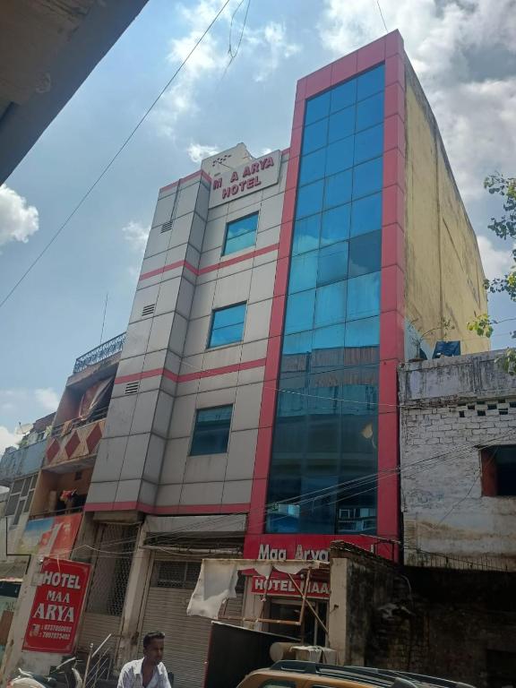 a tall building in a city at Hotel Maa Arya in Lucknow