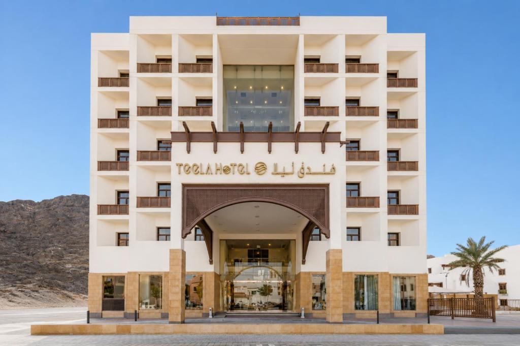 a hotel in the desert with an arch in front at فندق تيلا TeeLA HoTeL in Medina