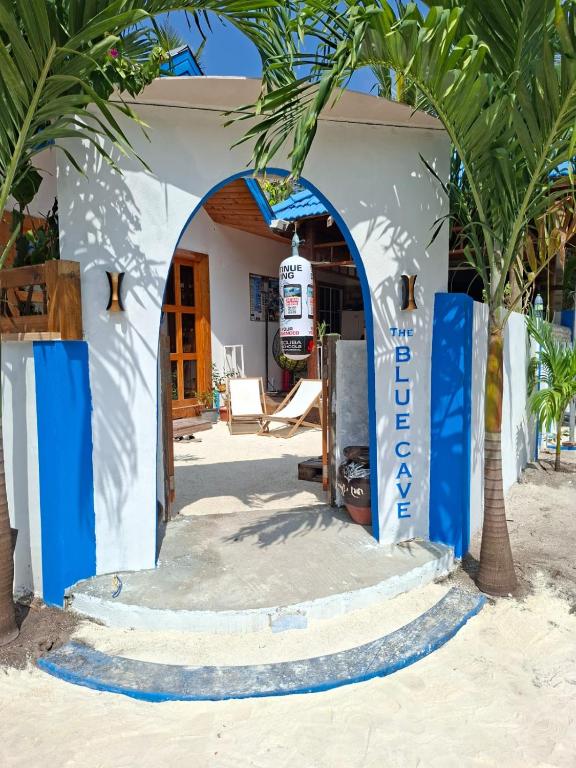 a house on the beach with a welcome sign at The Blue Cave Maldives in Kendhoo