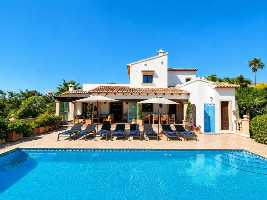 a villa with a swimming pool in front of a house at Villa Villa Lantana by Interhome in Jávea