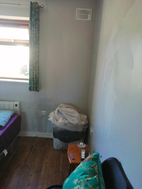 a living room with a couch and a window at The bungalow in Waterford Manor Station