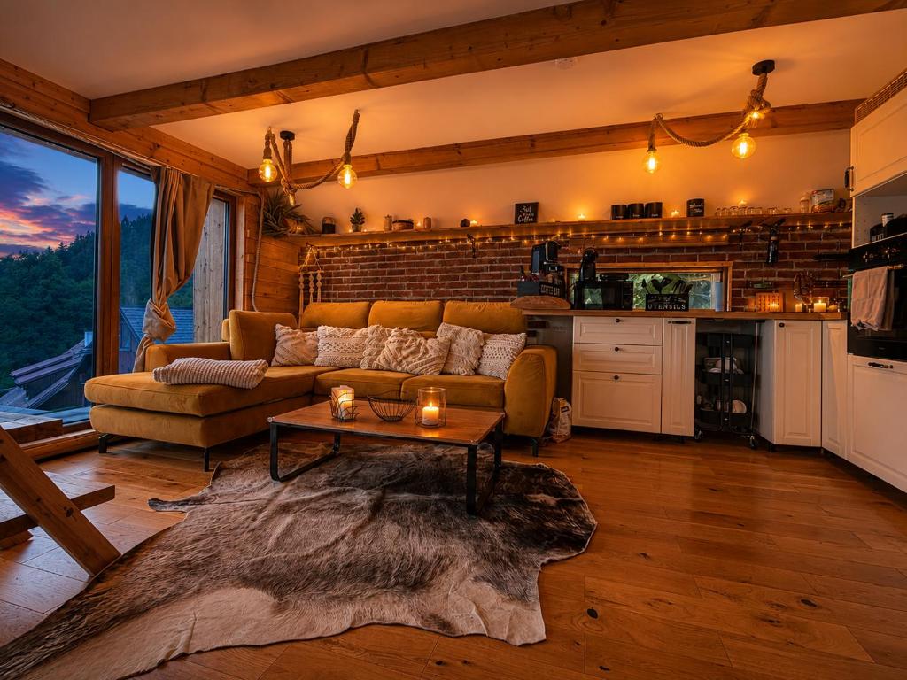 a living room with a couch and a table at Chata Malenovice in Malenovice