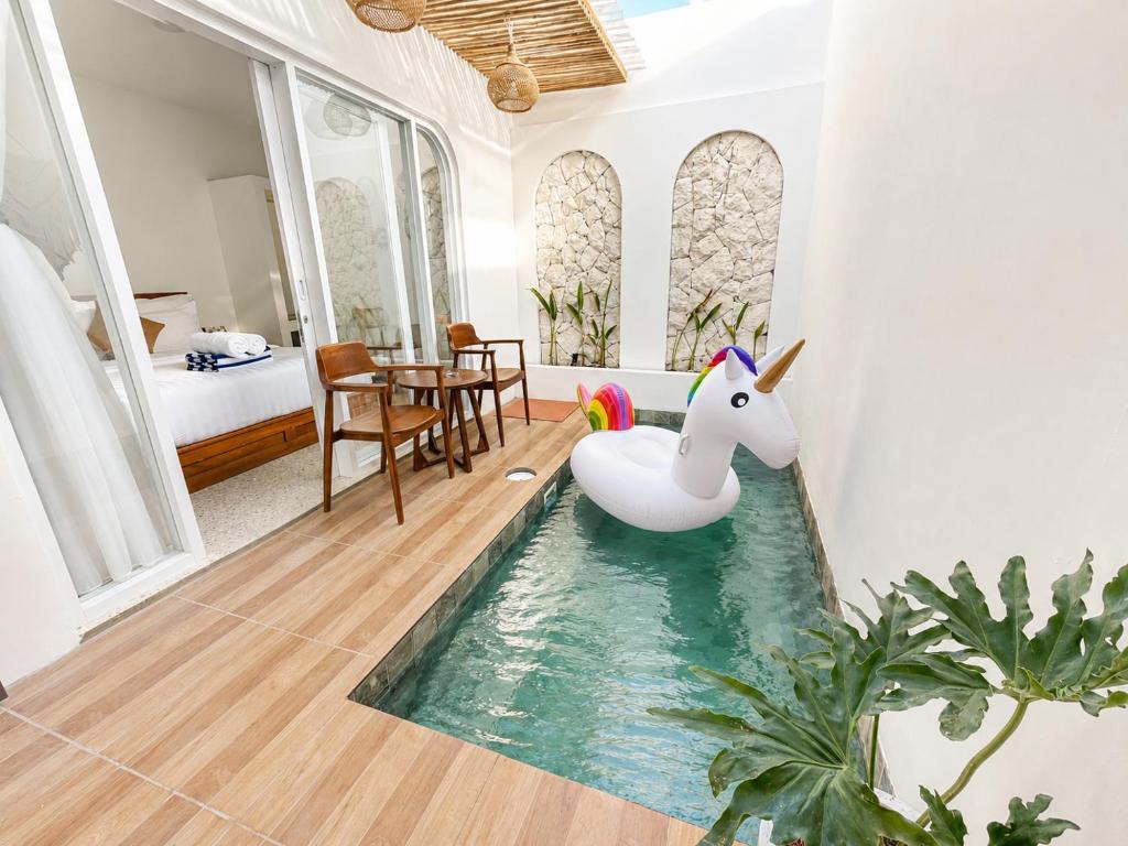 a room with a pool with a unicorn in it at Ayodhya Villa Patran in Kejayan