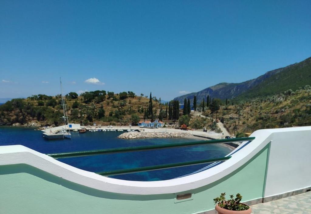 a boat sitting on the water near a harbor at DiPo's Beachside House with Sea View in Samos