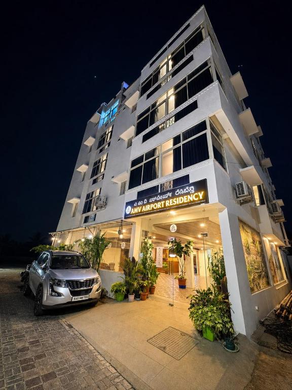 a car parked in front of a building at night at AMV Airport Residency in Bangalore