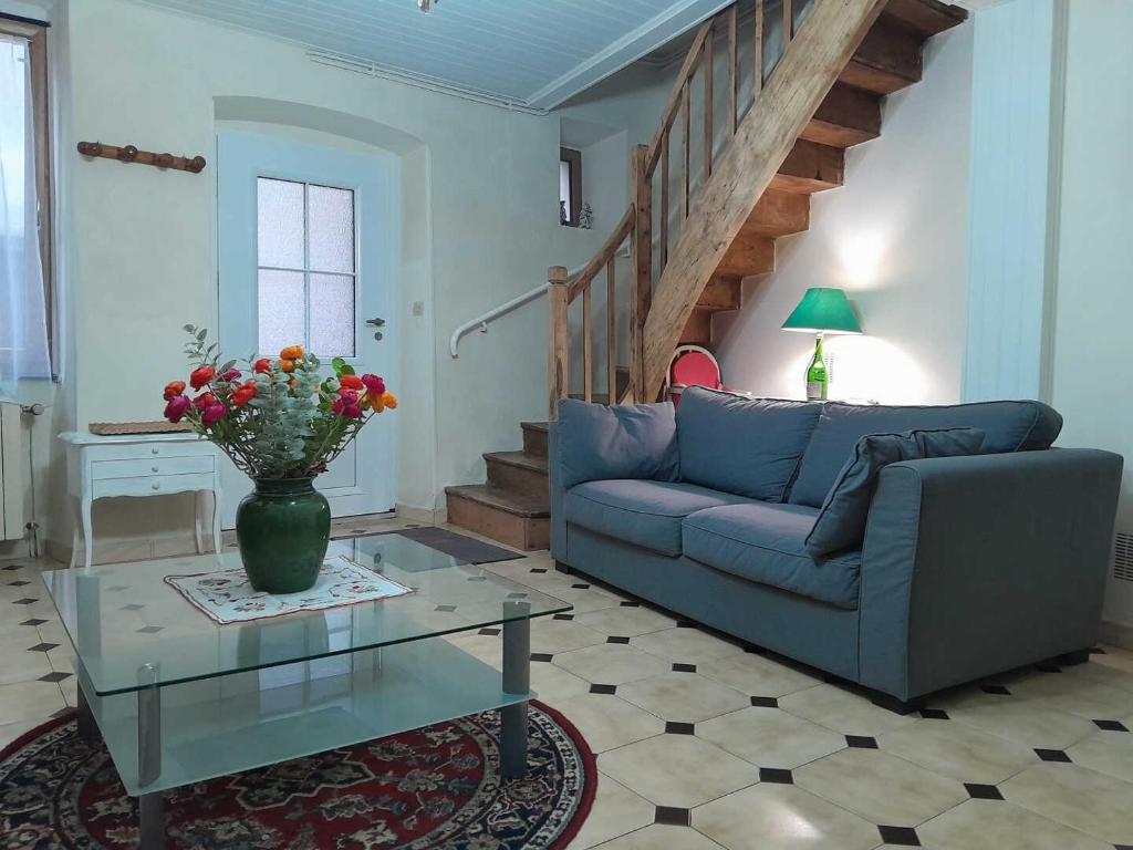 a living room with a couch and a table at Oustal marcellin in Fanjeaux