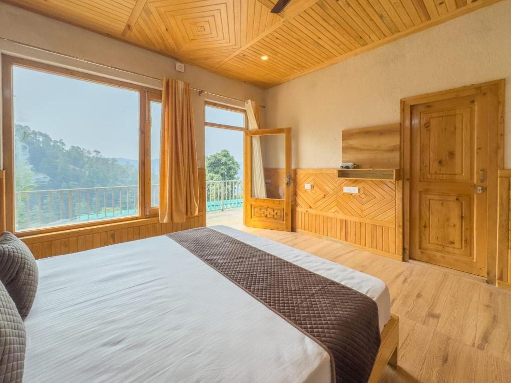 a bedroom with a bed and a large window at Silent Stone Homestay in Almora