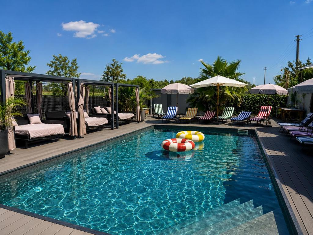 a swimming pool with balls in the water at Baco Da Seta Residence con Piscina - Venezia Mestre in Mestre