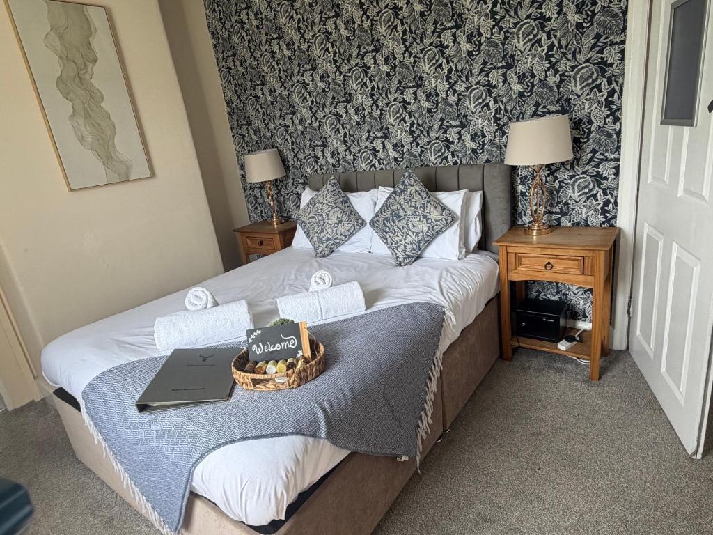 a bedroom with a bed with a laptop on it at The Bickerton Poacher in Higher Burwardsley