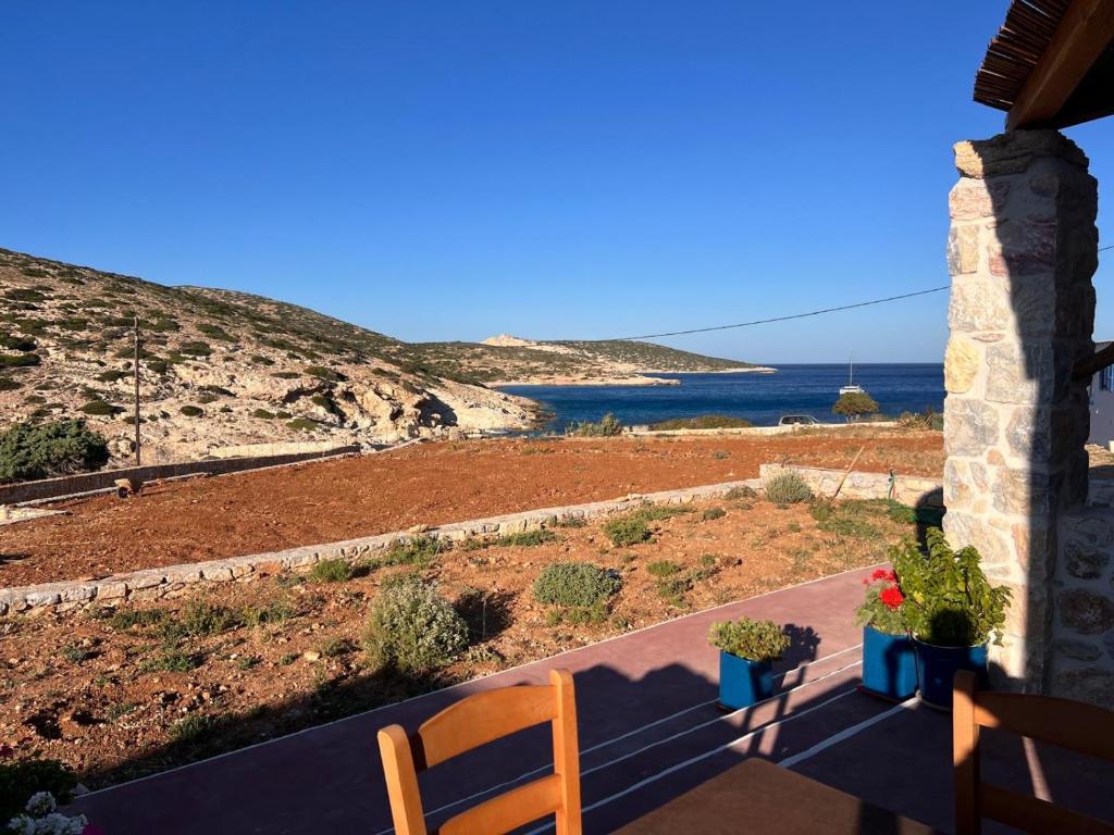 a balcony of a house with a view of the ocean at KOLOMBA GUESTS House in Vrachonisída Skylonísi