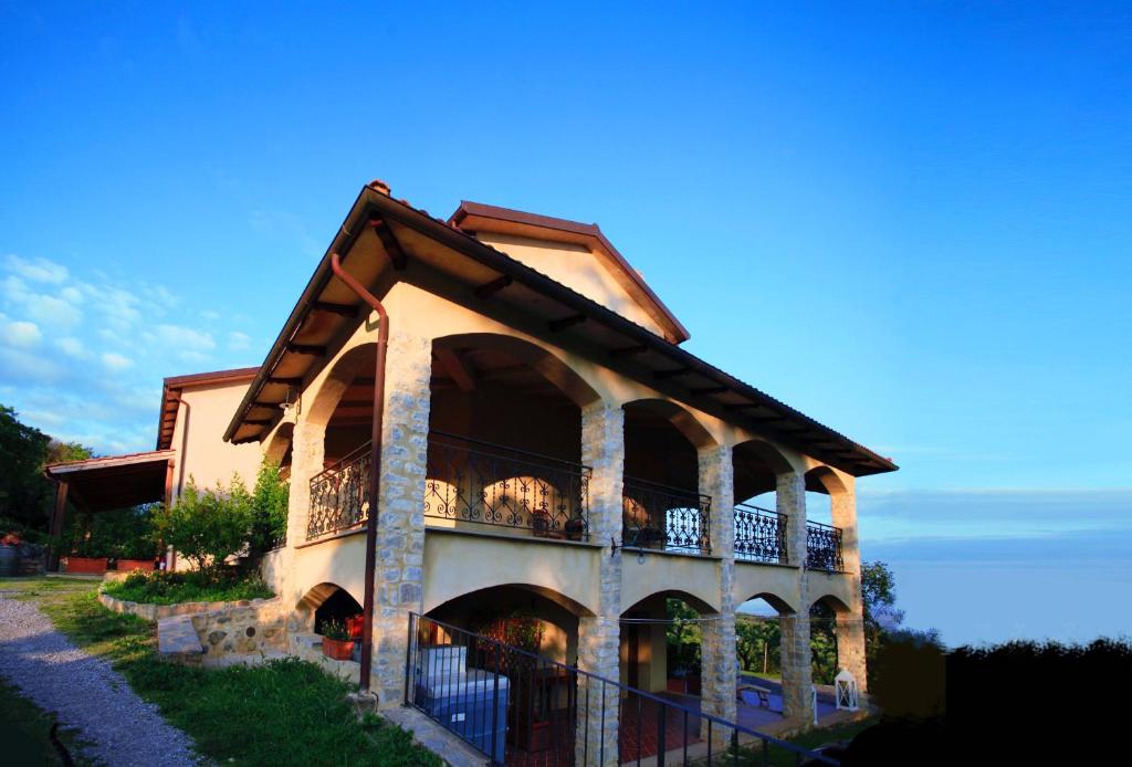 a building with a balcony on the side of it at Vitabella Toscana in Seggiano