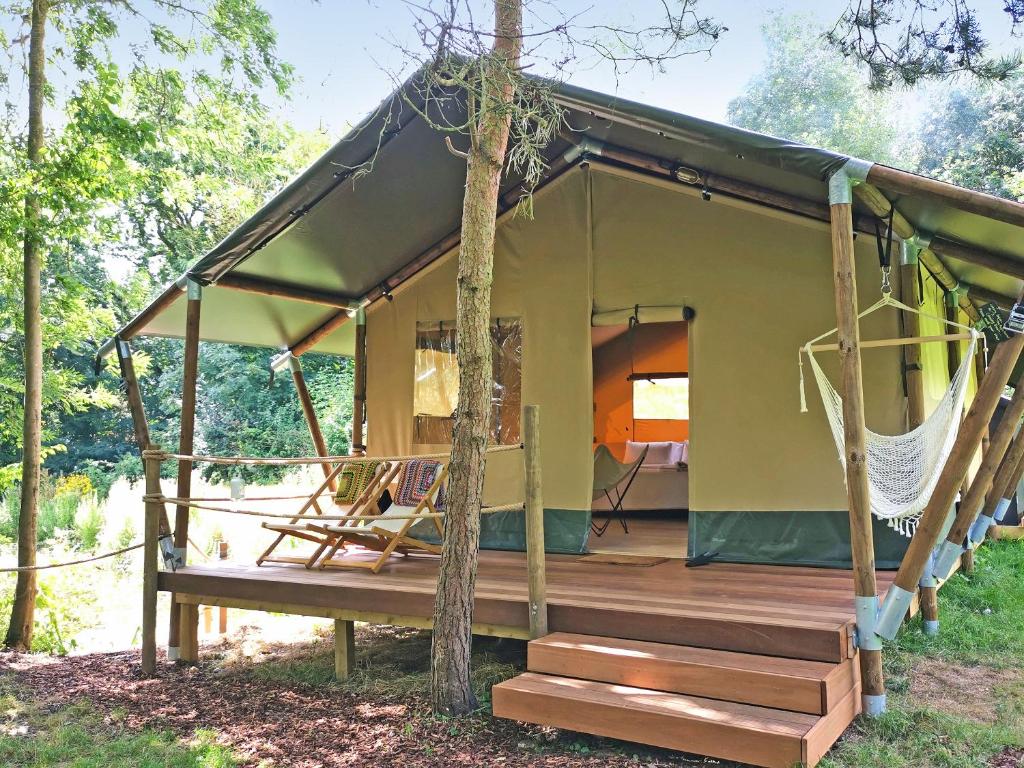 a green house with a porch and a deck at The Apple Bobber - Ukc7130 in Cratfield