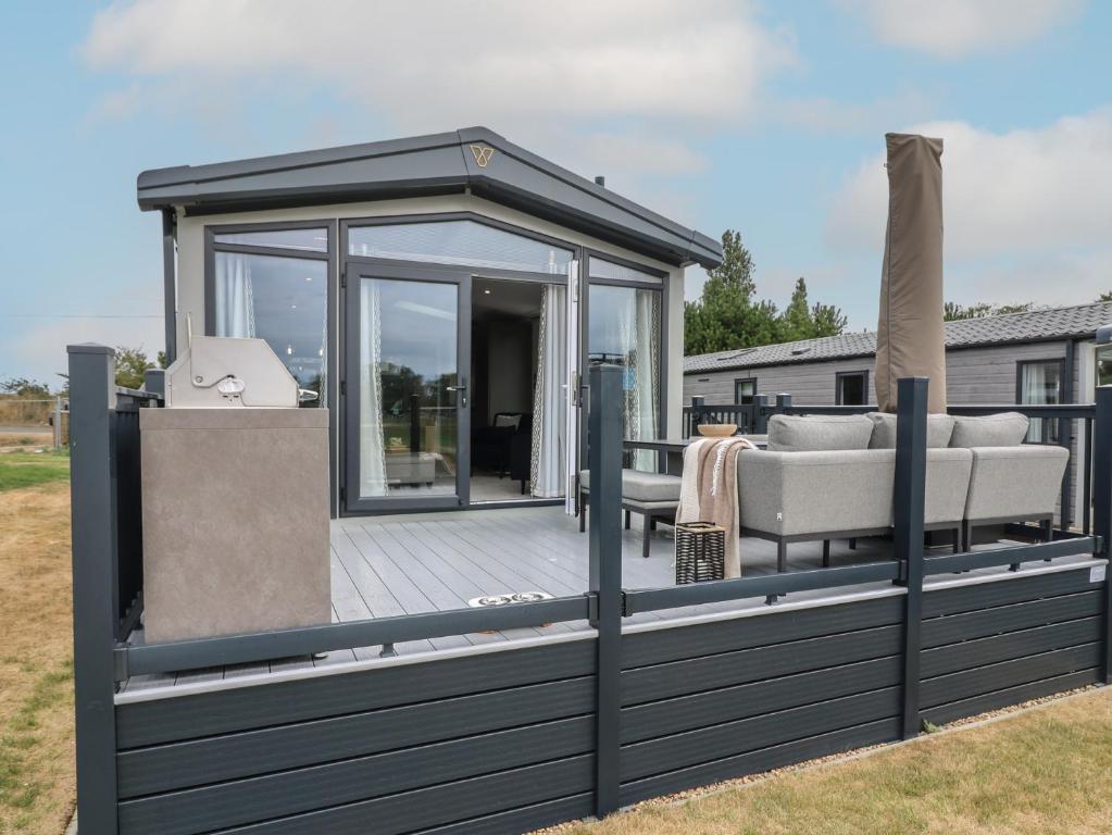 a deck with a gazebo and a couch at Lakewood Plot 2 in Clacton-on-Sea