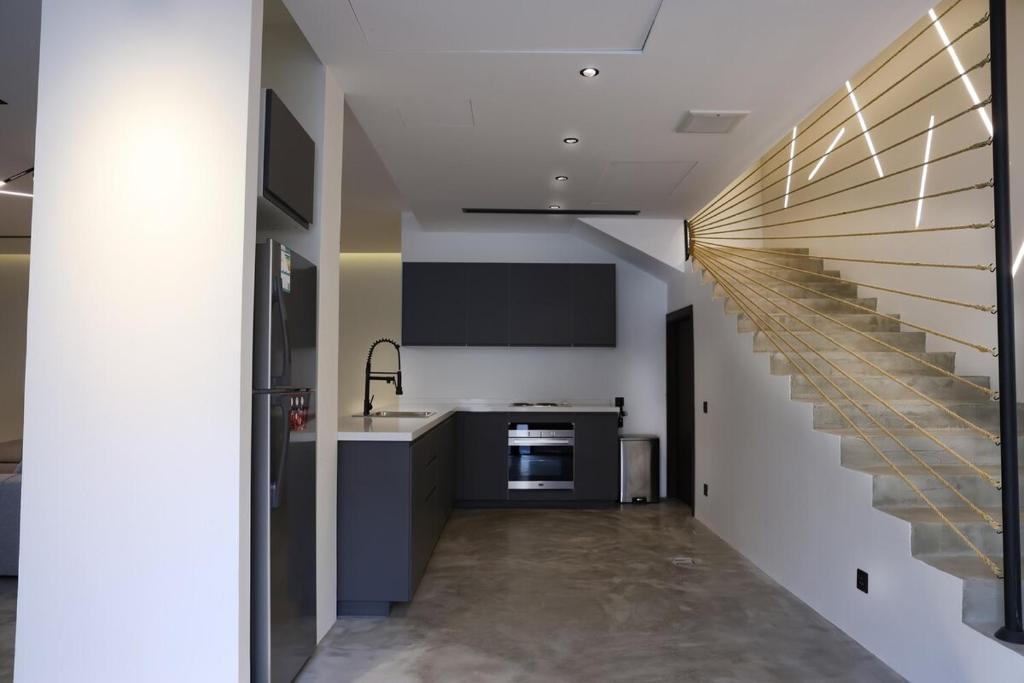 a kitchen with a staircase leading up to a kitchenasteryasteryasteryasteryasteryastery at Eight House villa in Jeddah