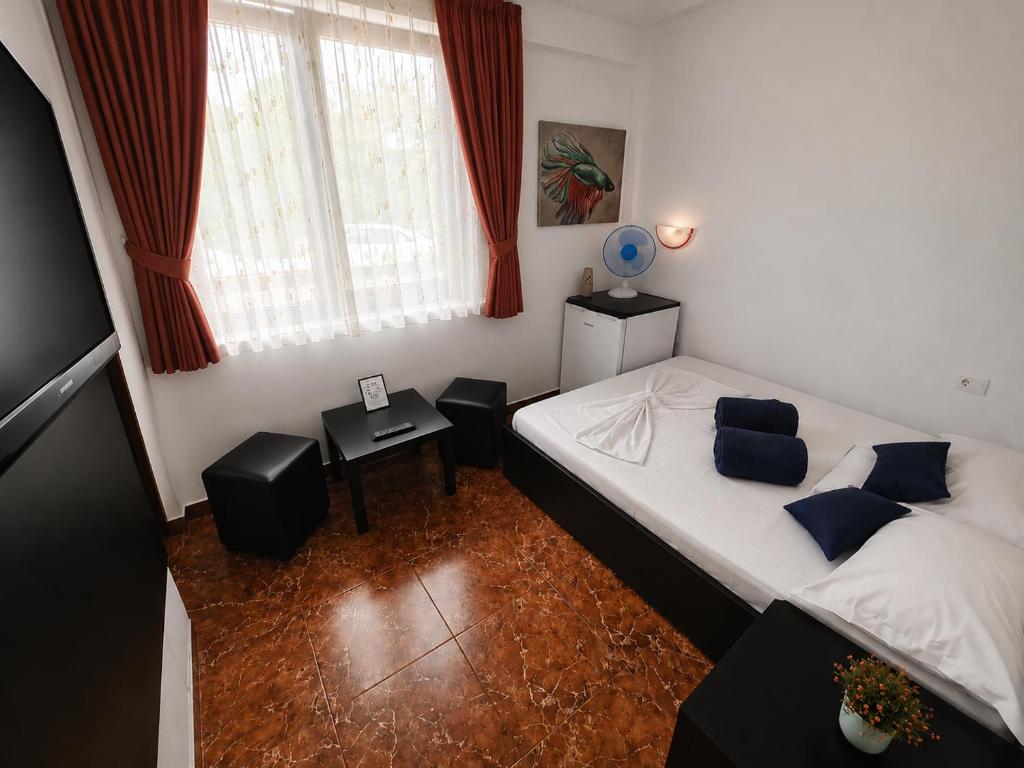 a small bedroom with a bed and a window at Sea View Smart Choice in Costinesti