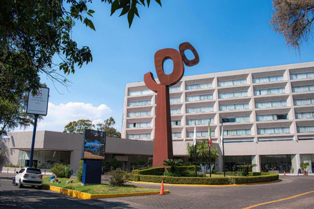 a large red sign in front of a building at Grand Cantalagua Hotel Morelia, BW Signature Collection in Morelia