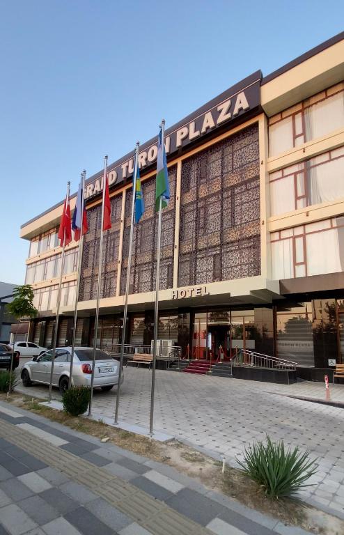 a large building with flags in front of it at Grand Turon Plaza Hotel in Tashkent