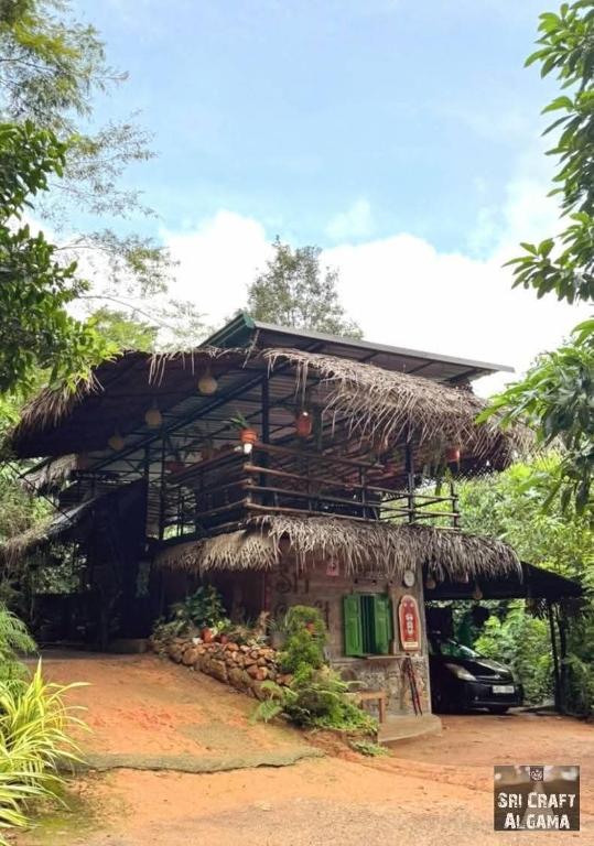 a small building with a straw roof at Sri Craft Algama in Uduwaka