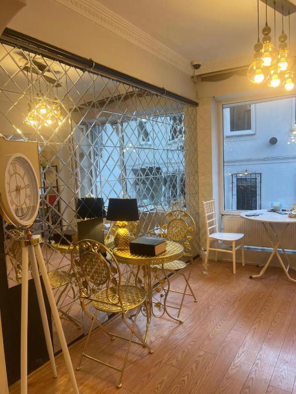 a room with a table and chairs and a window at Petek Hotel in Bursa