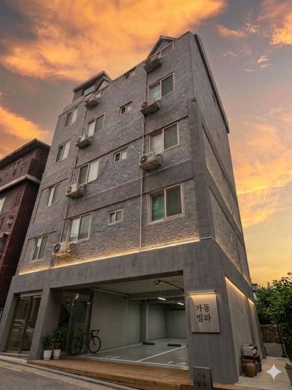 a gray building with writing on the side of it at Minimo Stay in Pyeongtaek