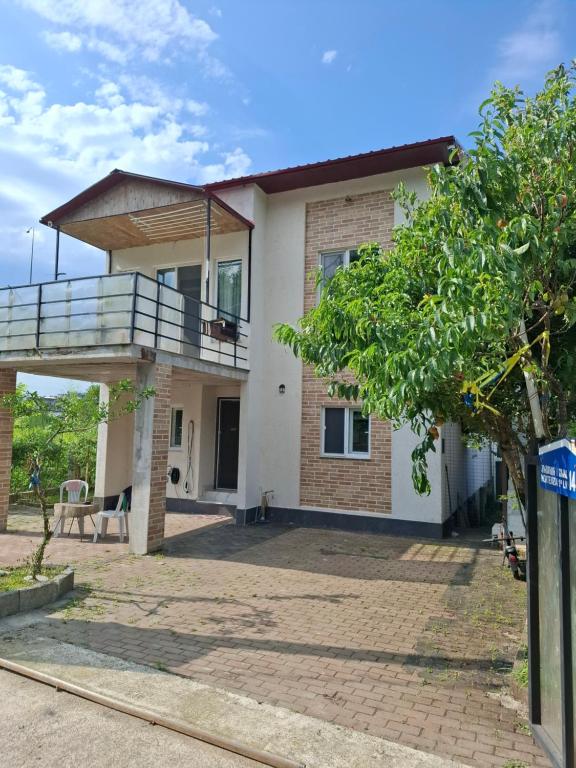 a house with a balcony and a patio at emplus in Batumi