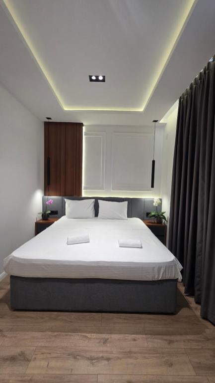 ein Schlafzimmer mit einem großen Bett mit weißer Bettwäsche in der Unterkunft Hotel Velaris in Struga